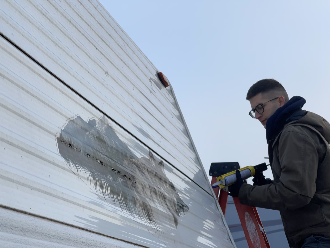 Technician performing RV leak inspection